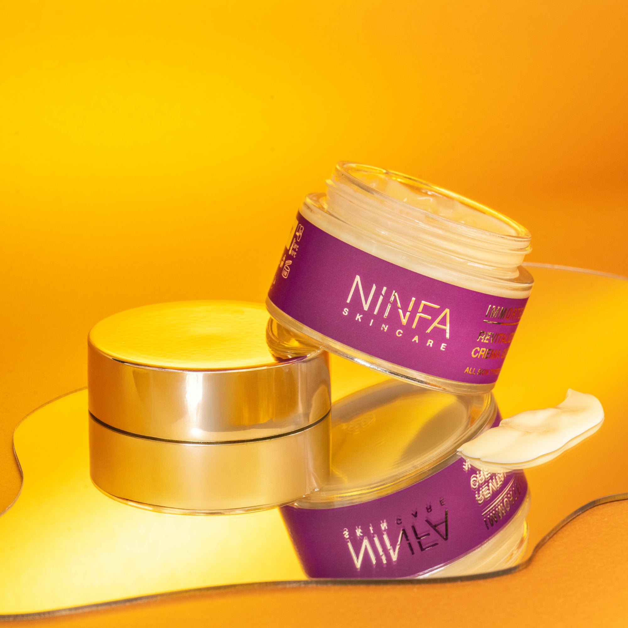 Crema viso all’elicriso di Ninfa Skincare su piccolo specchio irregolare, con dettaglio della consistenza